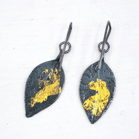 Pohutukawa leaf earrings in textured oxidised silver with 24ct gold details. These are made by HerbertandWilkes. Amazing hand crafted NZ jewellery at Mason and Collins.