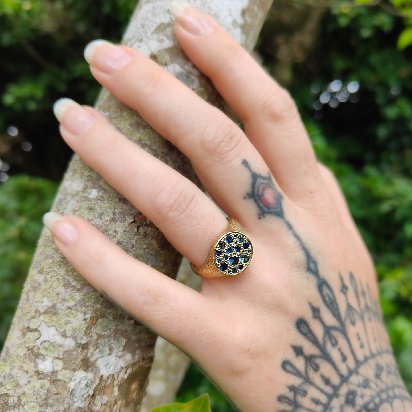 The solid gold Stardust Signet ring set with Australian green and blue sapphires by Adele Stewart. Amazing hand made NZ gold jewellery at Mason and Collins.