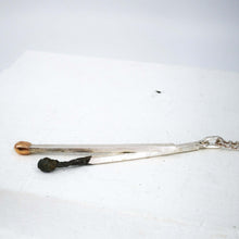 Load image into Gallery viewer, The Match Stick series pendant with burnt and live matches made from sterling silver and gold by David McLeod.