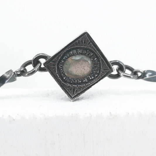 This statement necklace handcrafted by NZ jeweller Vaune Mason features hand-twisted silver chain links and a one-of-a-kind setting.