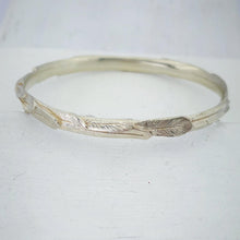 Load image into Gallery viewer, The feather bracelet in bright sterling silver from iconic NZ jewellery brand The Wild.
