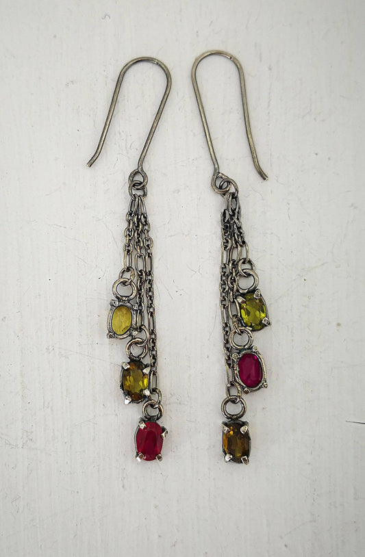 These gem cluster earrings hold olive green tourmaline and pink lab sapphires in small silver settings. Hand crafted by Vaune Mason.