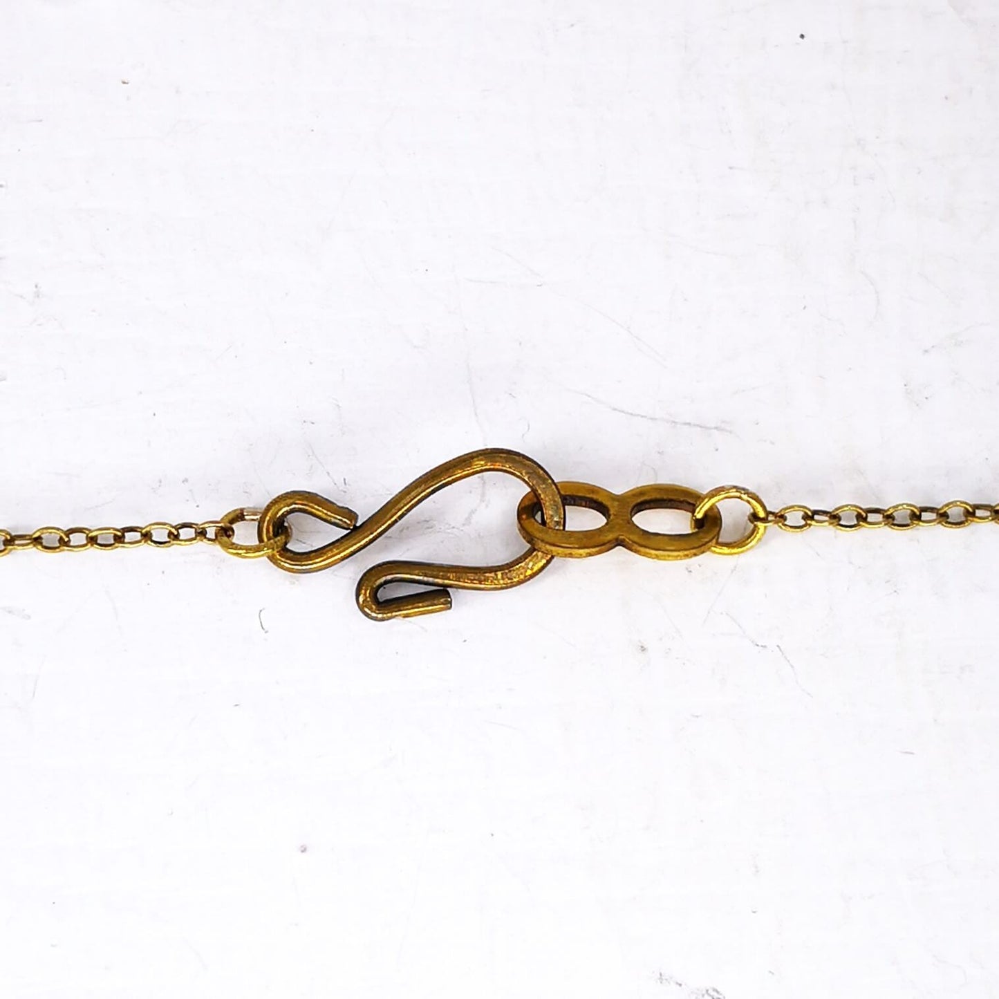 The sturdy hook and eye catch used on The Fern Frond Pendant in bronze.