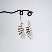 Load image into Gallery viewer, These light silver earrings are hand crafted in the shape of the NZ native Kowhai leaf. Made by Ruru Jewellery and available at Mason and Collins.