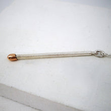 Load image into Gallery viewer, The live match pendant is cleverly made from solid sterling silver with a 9ct rose gold match head. Handmade NZ jewellery by David McLeod at Mason and Collins.