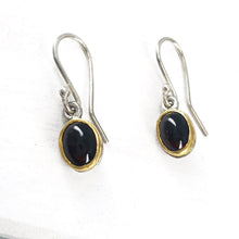 Load image into Gallery viewer, These oval garnet earrings in sterling silver and 22carat yellow gold are hand crafted in NZ by David McLeod. Handmade NZ jewellery available at Mason & Collins.