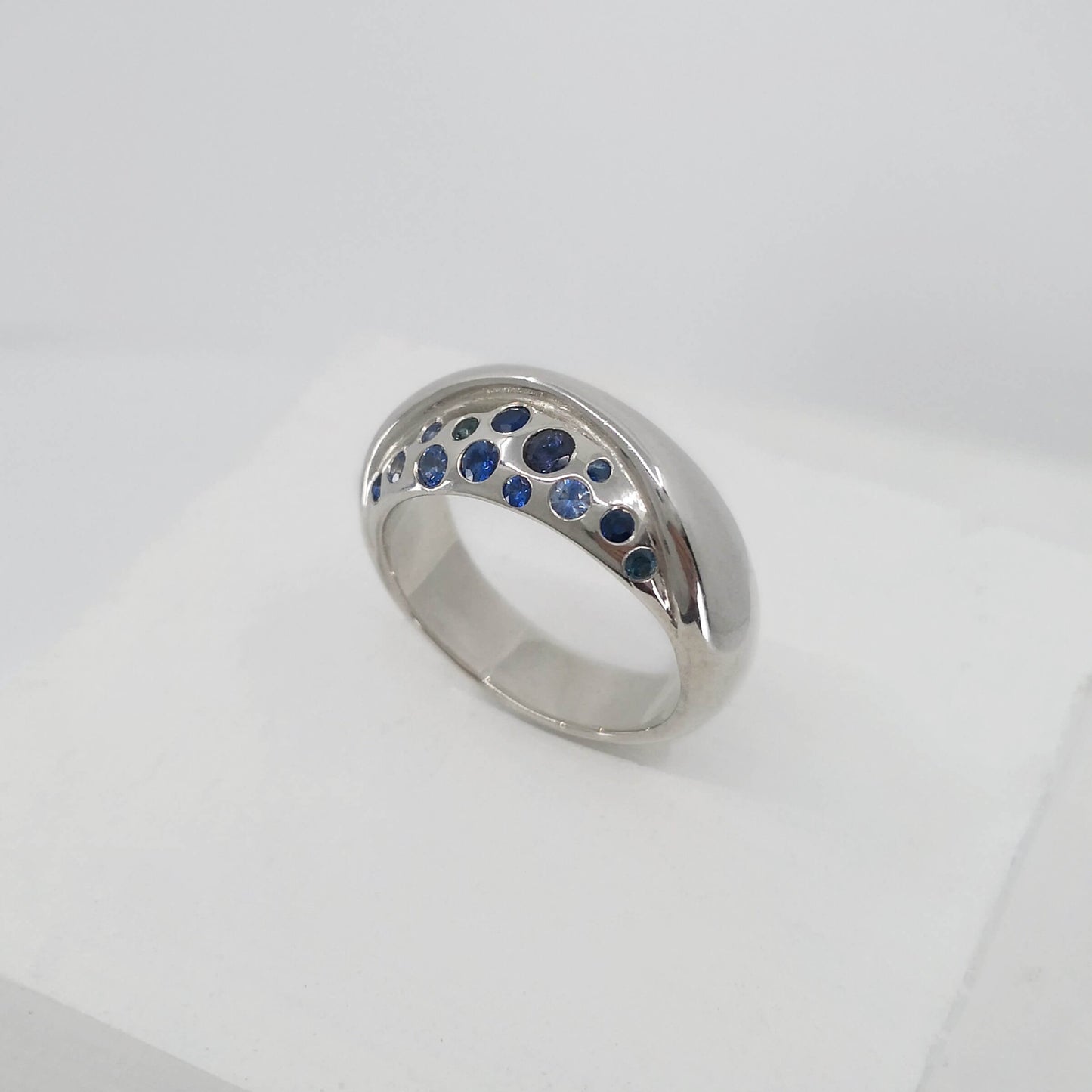 The Whenua Ring in solid sterling silver set with multi toned sapphires. Handcrafted NZ jewellery from Vaune Mason available at Mason & Collins.