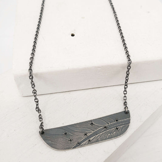 The Matariki Necklace in oxidised sterling silver by NZ jeweller Buster Collins.