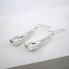 Load image into Gallery viewer, The silver petal earrings by NZ jeweller Buster Collins are simple and sleek easy-to-wear jewellery.