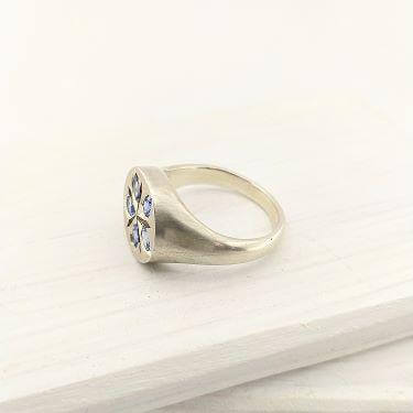 The beautiful Star Flower Borage ring is hand crafted by Adele Stewart in solid sterling silver and ceylon sapphires.