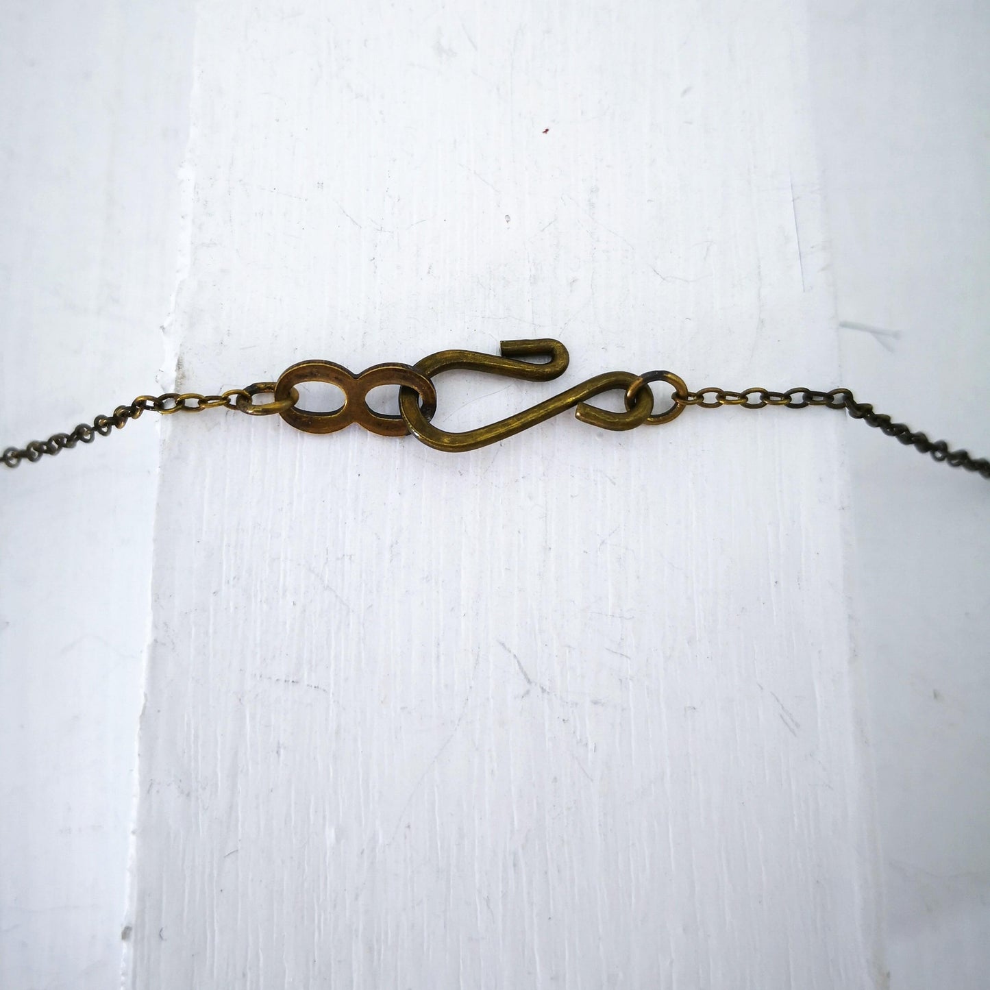 The bronze catch for the Huia Beak charm pendant. Made by The Wild Jewellery NZ.