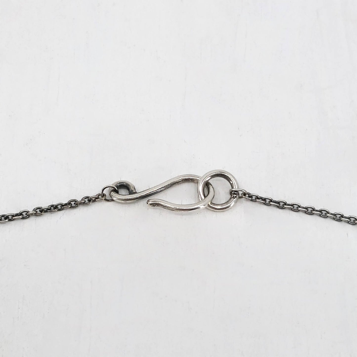 Silver Dog Pendant handmade by Vaune Mason. This cute wee dog hangs from a sturdy solid silver chain. Quality silver jewellery available at Mason and Collins.