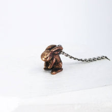 Load image into Gallery viewer, The Very Tiny Bunny necklace by Vaune Mason features a delicately carved bunny charm cast in warm bronze on a sterling silver chain.
