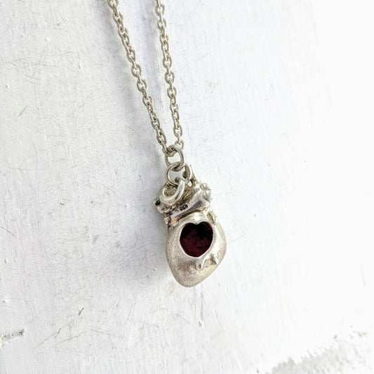 Handmade in New Zealand, this is a silver necklace with an anatomical heart pendant and red enamel detailing.