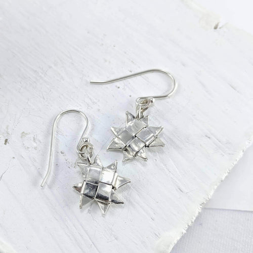 The Whetū (Star) earrings by Keri-Mei Zagrobelna are hand woven strips of fine silver into a little star-shape. They hang on sterling silver hooks. 