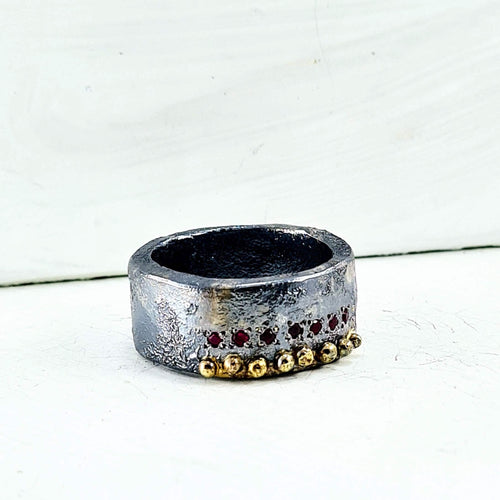 This is a super chunky silver and gold ring set with 7 little rubies. Hand crafted NZ jewellery made by Natalie Salisbury Jewellery - available at Mason and Collins.