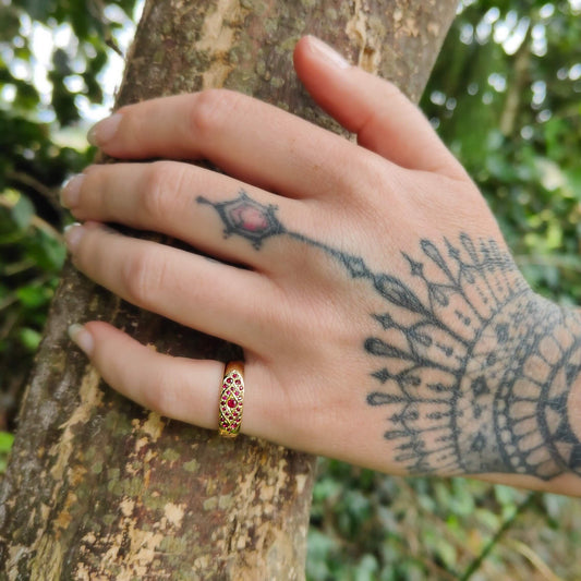 The Celtic ring in 9ct yellow gold and set with rubies by Adele Stewart. Quality hand crafted NZ gold jewellery available at Mason and Collins.