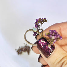 Load image into Gallery viewer, The pinky tones of the little opal in this silver hefring by Banshee the Valkyrie look great next to purple berries!
