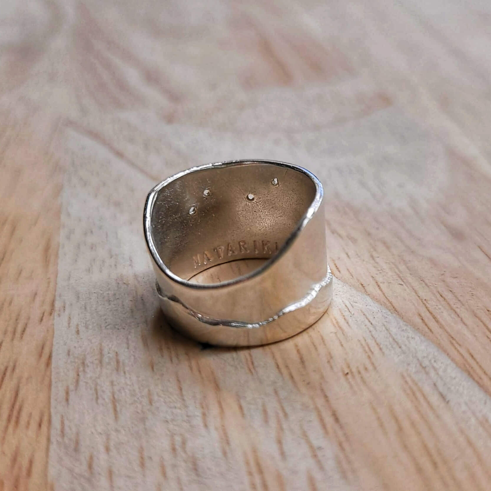 The Matariki Maunga Ring is a wide tapered band hand crafted in solid sterling silver by Buster Collins. Quality NZ silver jewellery available at Mason and Collins.