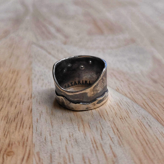 The Matariki Maunga Ring is a wide tapered band hand crafted in solid sterling silver by Buster Collins. Quality NZ silver jewellery available at Mason and Collins.