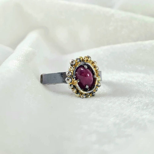 This ring features a stunning oval ruby cabachon  set in gold and oxidised silver. Hand crafted NZ jewellery made by Natalie Salisbury Jewellery. Available at Mason and Collins. 