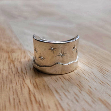 The Matariki Maunga Ring is a wide tapered band hand crafted in solid sterling silver by Buster Collins. Quality NZ silver jewellery available at Mason and Collins. 