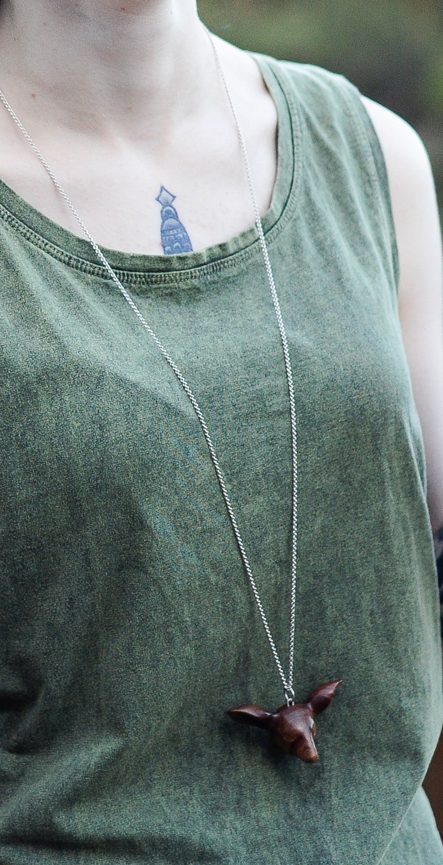 Our model wears the Doe's Head Necklace by NZ jeweller Vaune Mason.