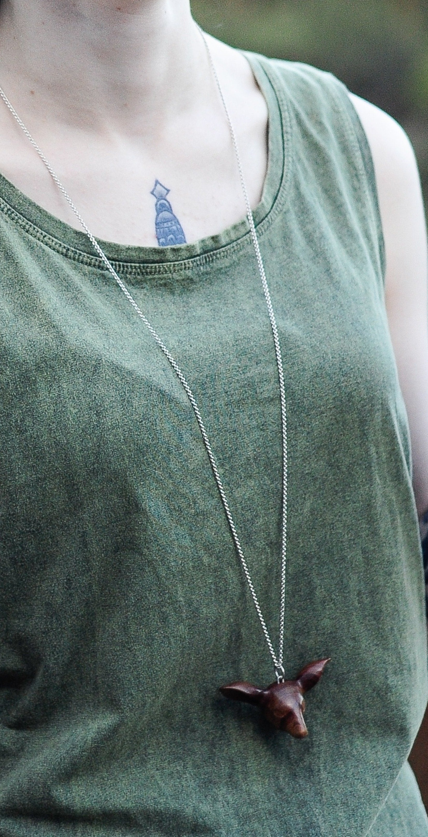 Our model wears the Doe's Head Necklace by NZ jeweller Vaune Mason.