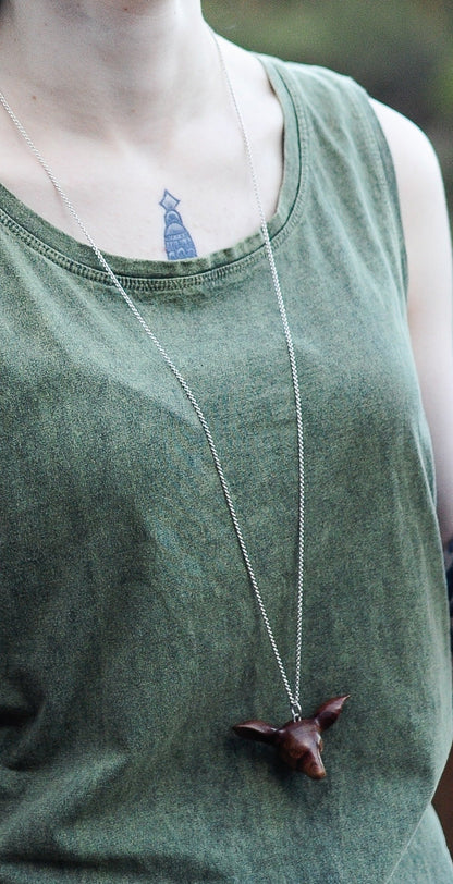 Our model wears the Doe's Head Necklace by NZ jeweller Vaune Mason.