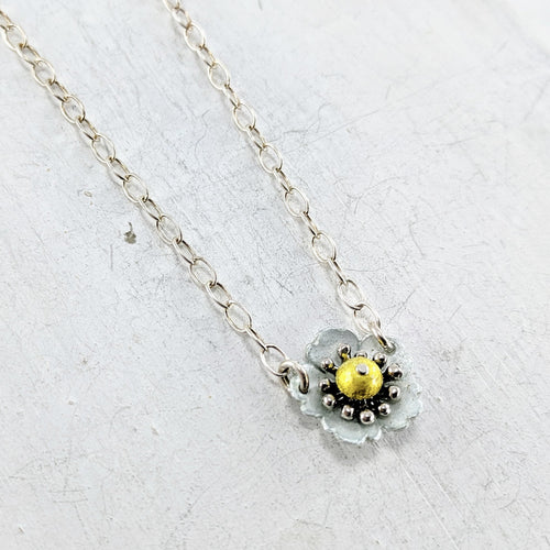 Handmade in New Zealand, this is a silver necklace with a enamelled fine silver alpine strawberry pendant yellow and blue