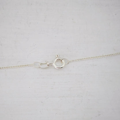 Close up of the small silver bolt-catch on the Ruru Pendant. From Ruru Jewellery.