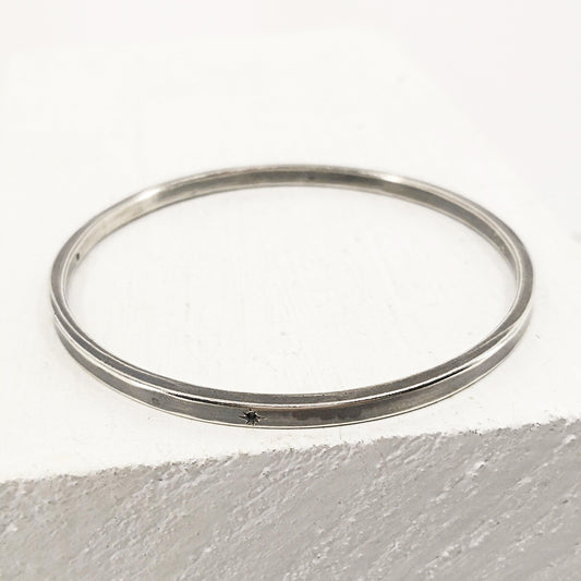 The Matariki Bangle in sterling silver, hand crafted in NZ by Buster Collins.