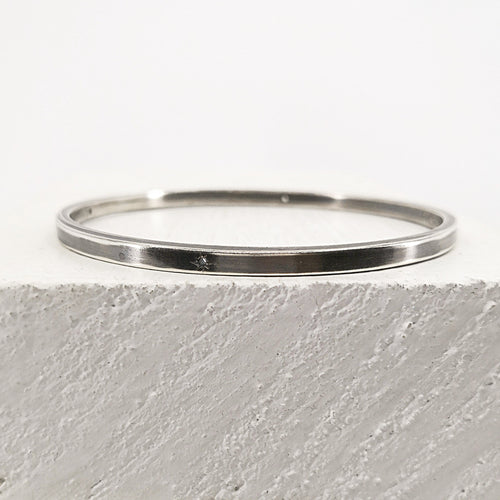The Matariki Bangle in sterling silver, hand crafted in NZ by Buster Collins.