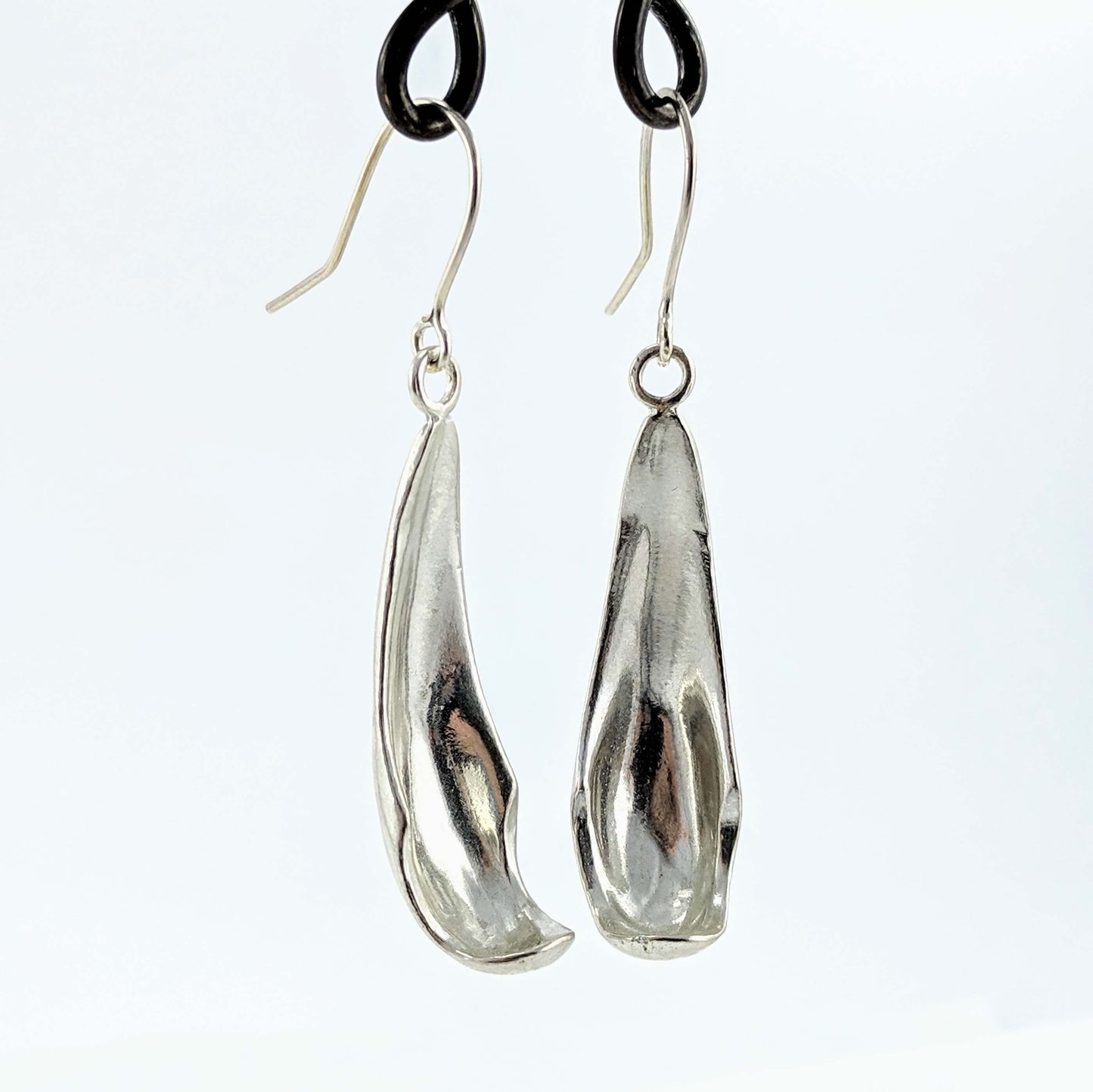 The silver petal earrings by NZ jeweller Buster Collins are simple and sleek easy-to-wear jewellery.