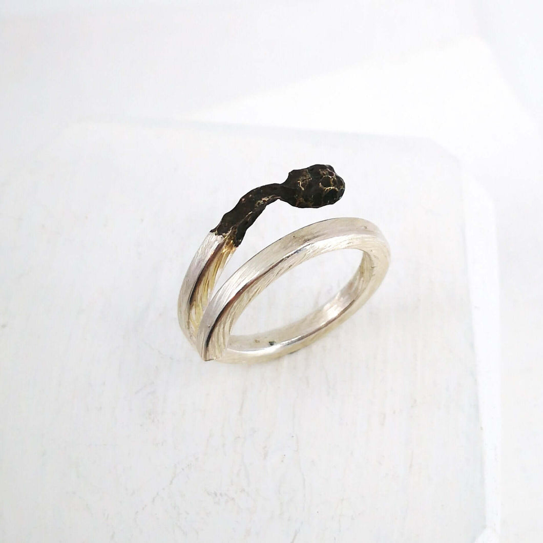 The Burnt Match Stick Ring is hand crafted by NZ jeweller David McLeod. A stunning solid sterling silver ring in a unique modern design available at Mason and Collins.