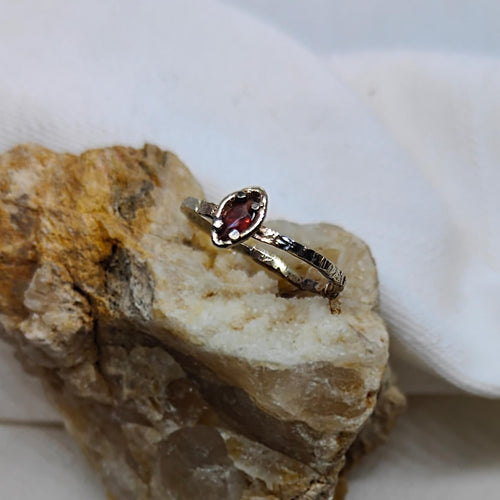 A magical gold and silver ring holding a red marquise cut sapphire. Handmade in NZ by Natalie Salisbury Jewellery. Ethical gold jewellery available at Mason and Collins.