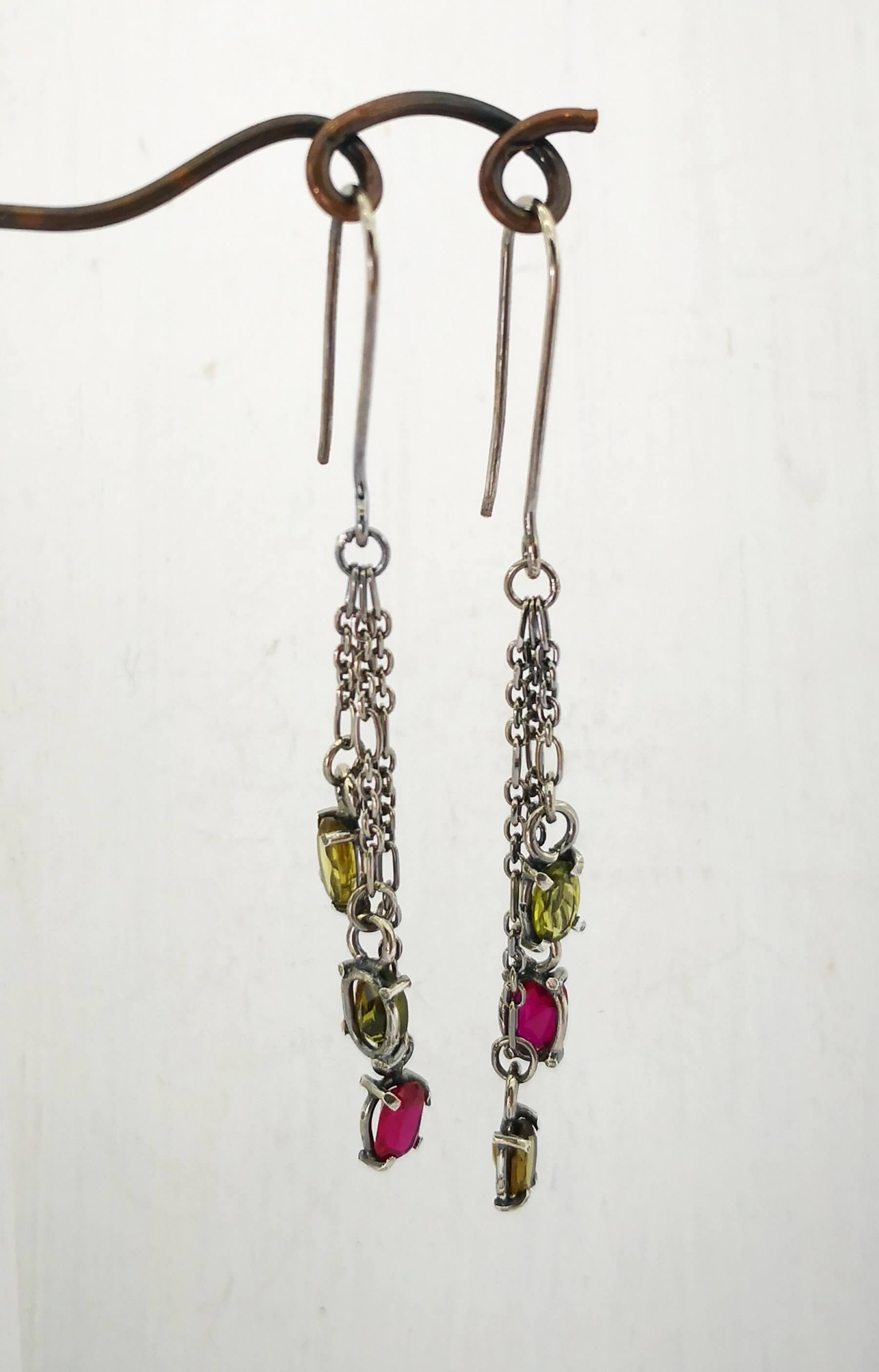 These gem cluster earrings hold olive green tourmaline and pink lab sapphires in small silver settings. Hand crafted by Vaune Mason.