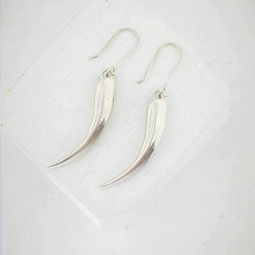 Solid silver Huia Beak earrings handmade NZ jewellery by The Wild.