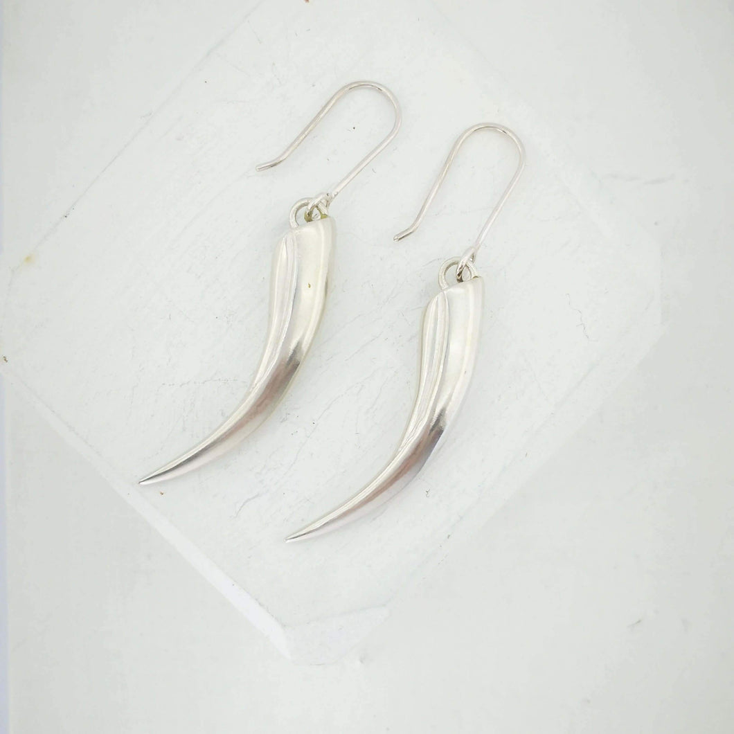 Solid silver Huia Beak earrings handmade NZ jewellery by The Wild.
