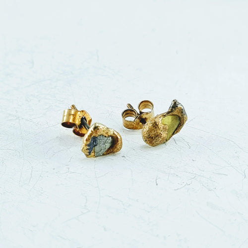Assymetrical organic shaped stud earrings with one grey and one yellow diamond sliver set into 9ct yellow gold with touches of oxidised silver. By Natalie Salisbury Jewellery.