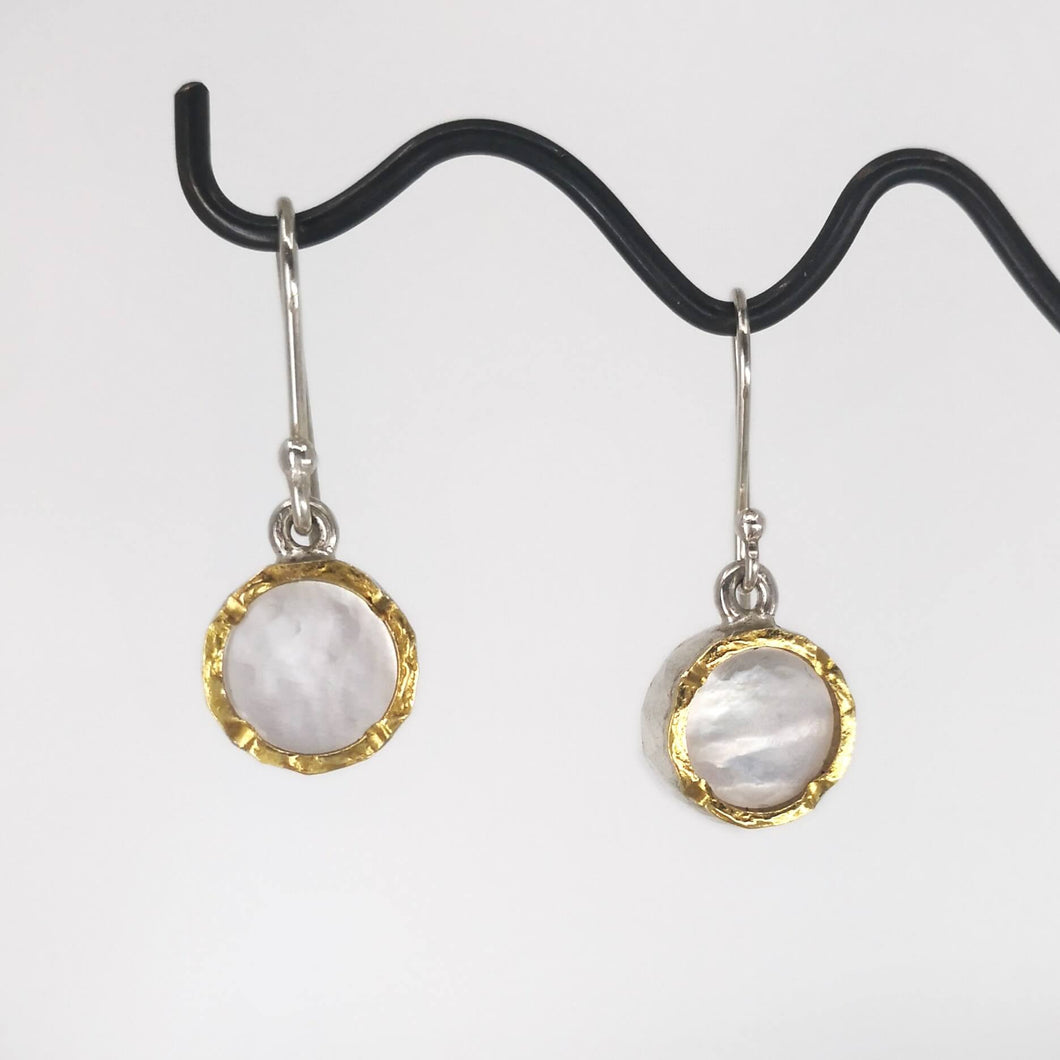 These classic drop earrings are hand crafted in sterling silver and mother of pearl shell. The rim on the front has a 22ct yellow gold trim so the earrings really catch the light. Made by David McLeod and available through Mason and Collins. 