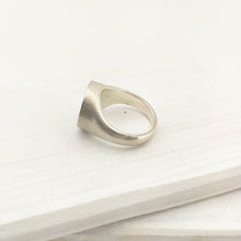 Load image into Gallery viewer, The Mount Cook Buttercup signet ring by Adele Stewart. NZ jewellery, handcrafted in sterling silver and set with a AAA grade yellow sapphire.
