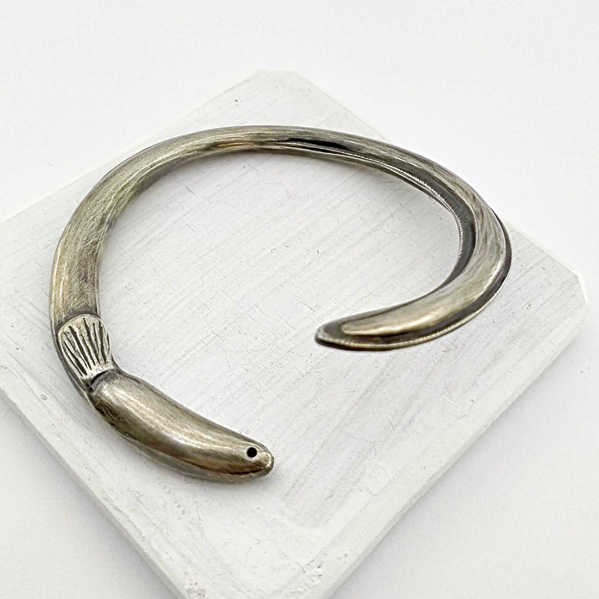The tuna bracelet is handmade in NZ by The Wild Jewellery. Cast in solid sterling silver this bracelet represents the endangered long-finned eel that is native to Aotearoa NZ.