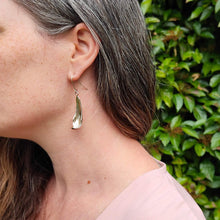 Load image into Gallery viewer, The silver petal earrings by NZ jeweller Buster Collins are simple and sleek easy-to-wear jewellery.
