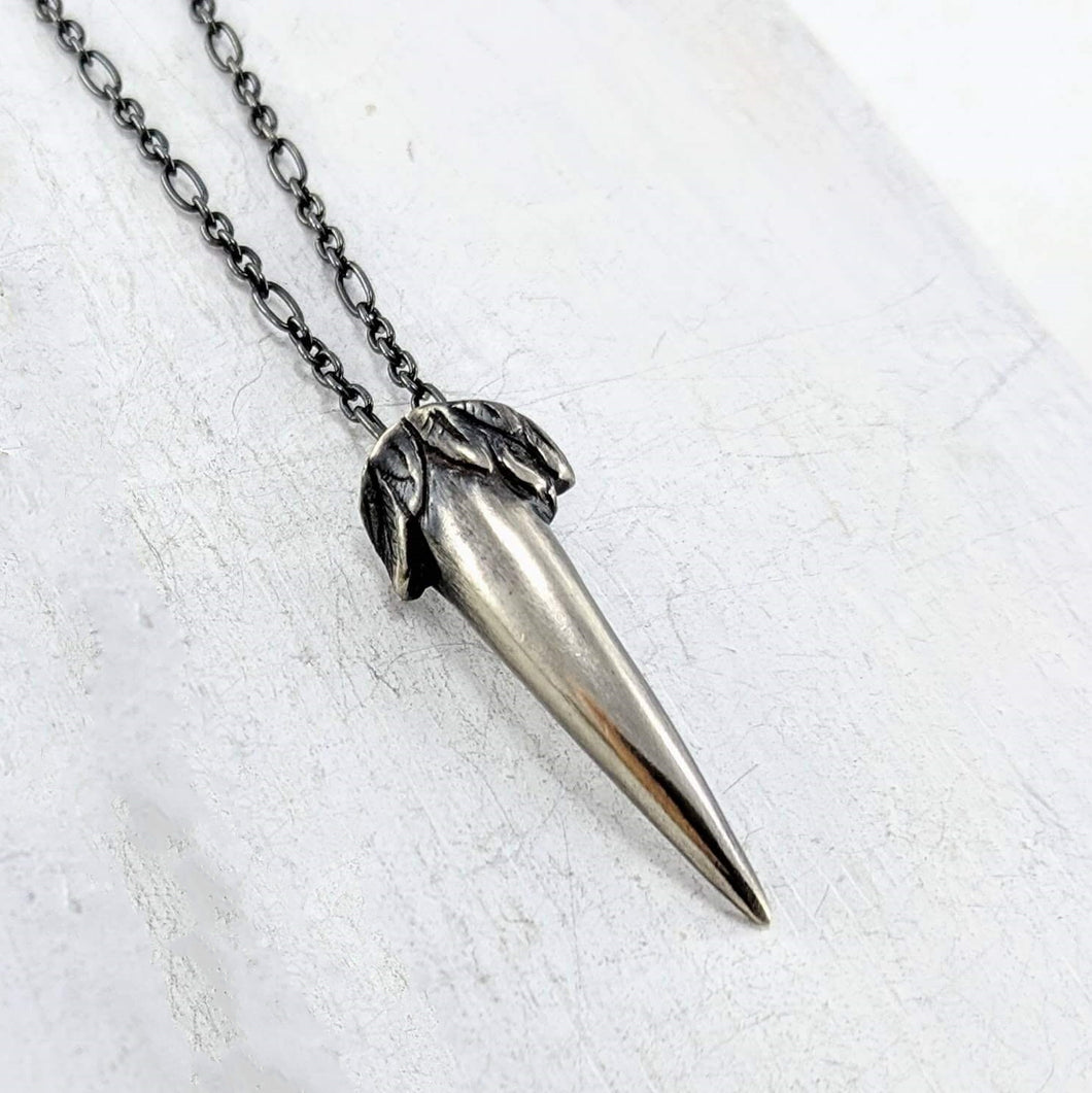 The Ruru Talon pendant is a hand carved silver charm in the shape of a small claw. The Ruru is the native owl of NZ, a small and shy bird with a distinctive call.