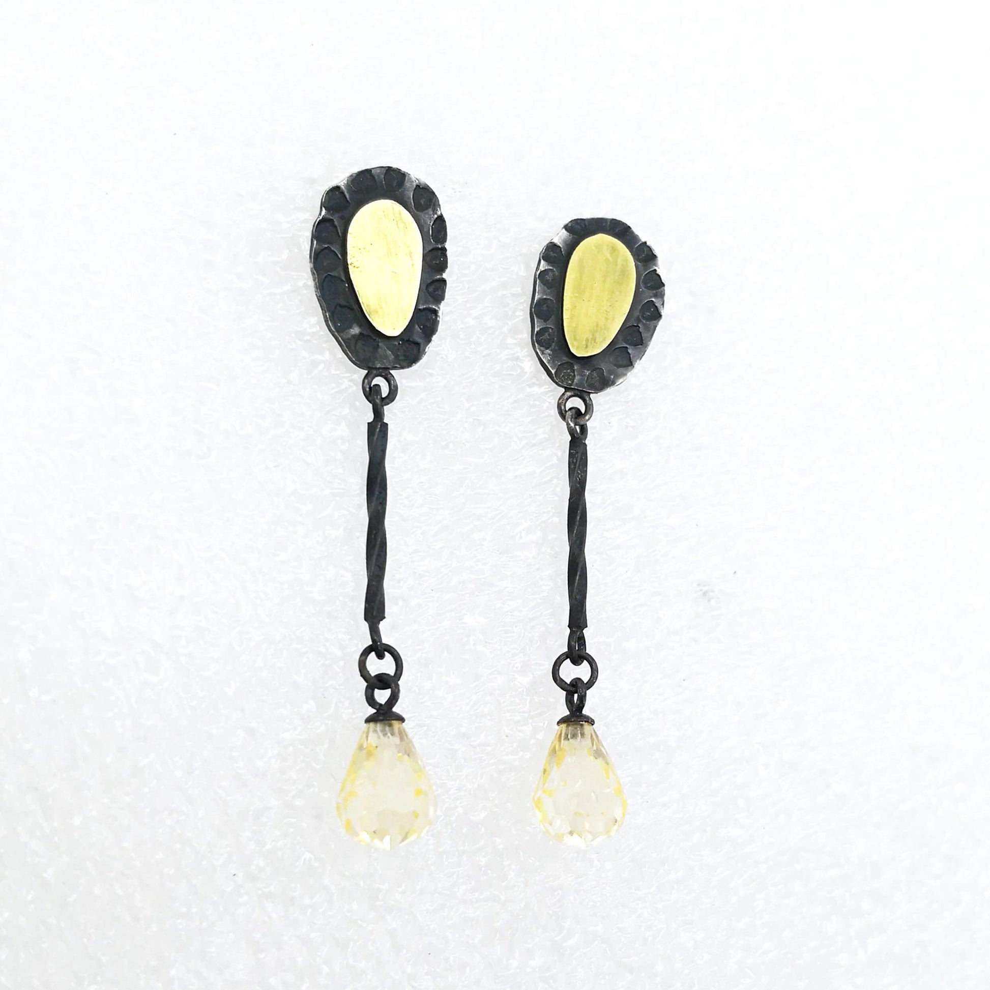 These delicate drop earrings are crafted in silver and 18 carat gold with delicate yellow cubic zirconia drops. By Vaune Mason.