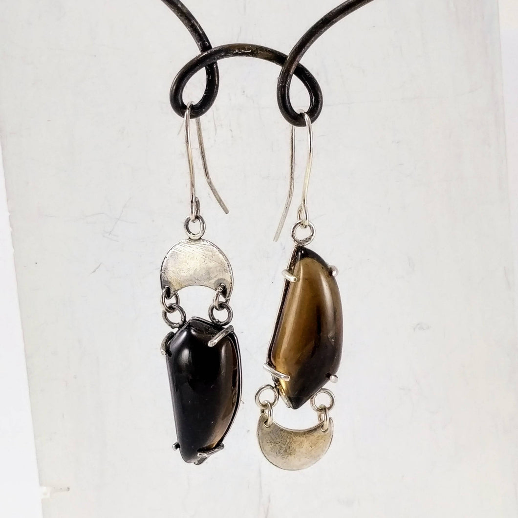The silver and smokey quartz celestial phase earrings by Buster Collins. 
