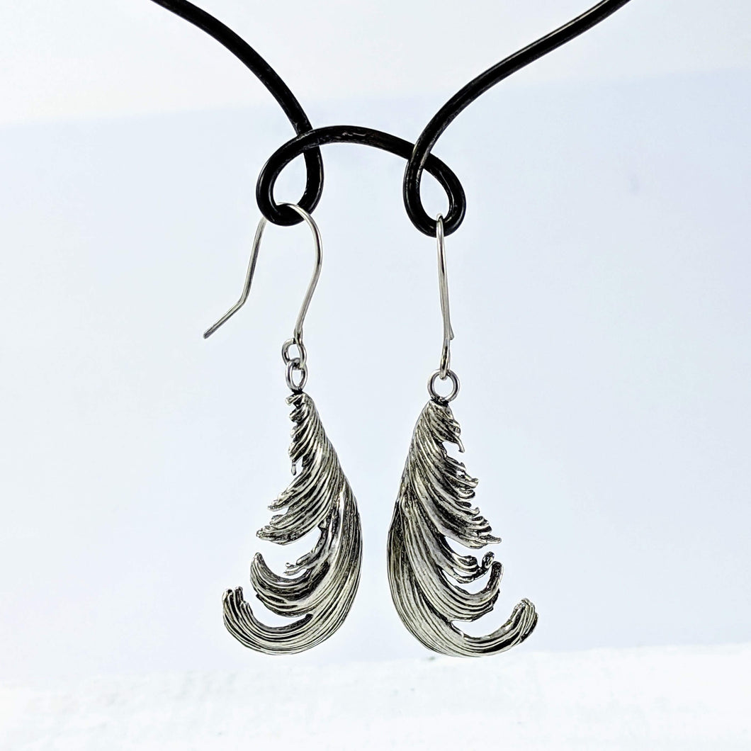 The silver feather earrings by NZ jeweller Buster Collins. 
