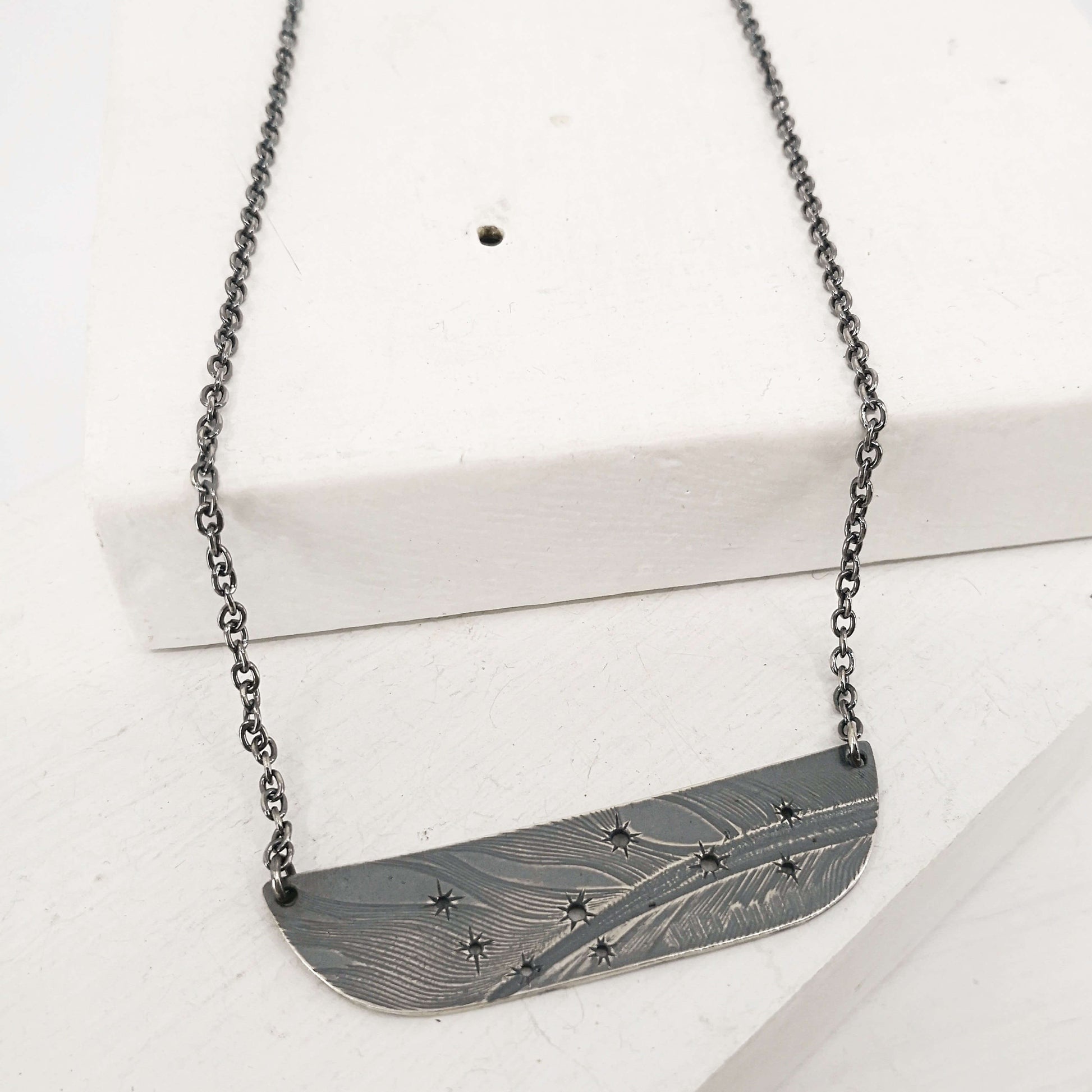 The Matariki Necklace in oxidised sterling silver by NZ jeweller Buster Collins.