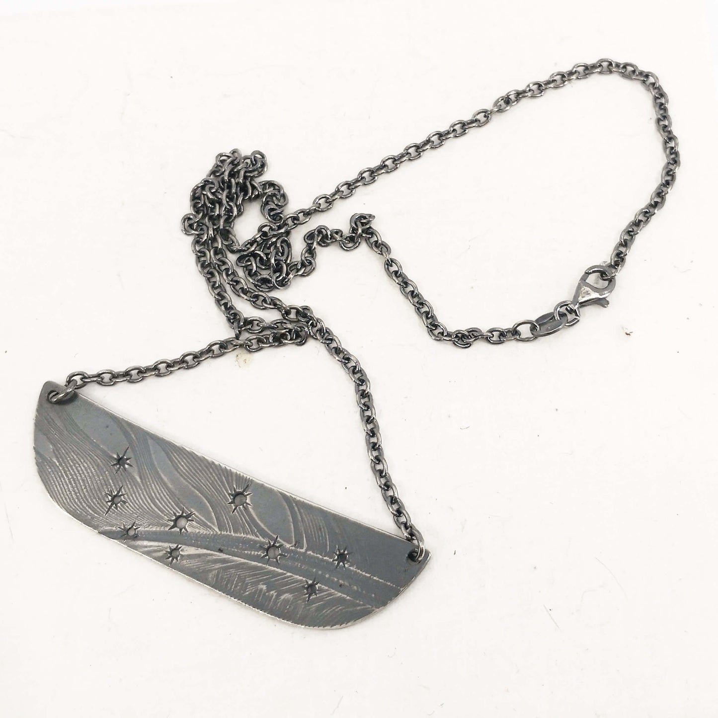 The Matariki Necklace in oxidised sterling silver by NZ jeweller Buster Collins.